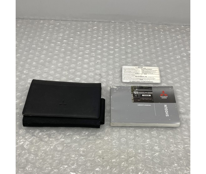 OWNERS HANDBOOK WITH WALLET FOR A MITSUBISHI V90# - PLATE & LABEL