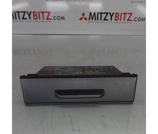 UNDER STEREO ACCESSORY BOX WITH LID TYPE FOR A MITSUBISHI MONTERO SPORT - K89W