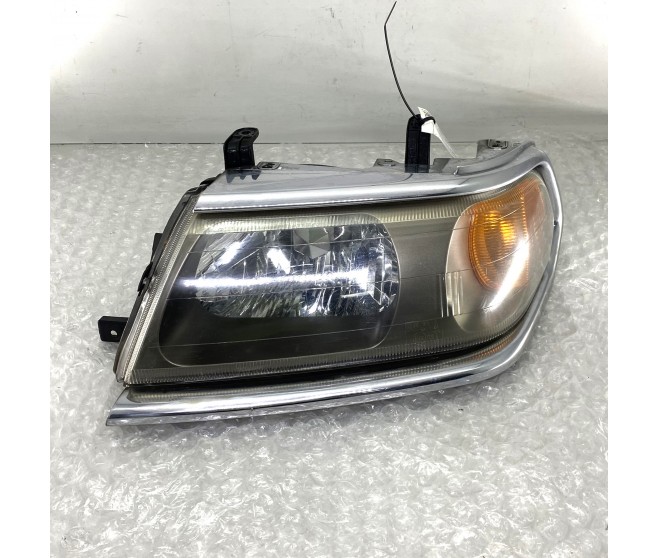 LEFT FRONT HEADLAMP FOR A MITSUBISHI PAJERO/MONTERO SPORT - K94W